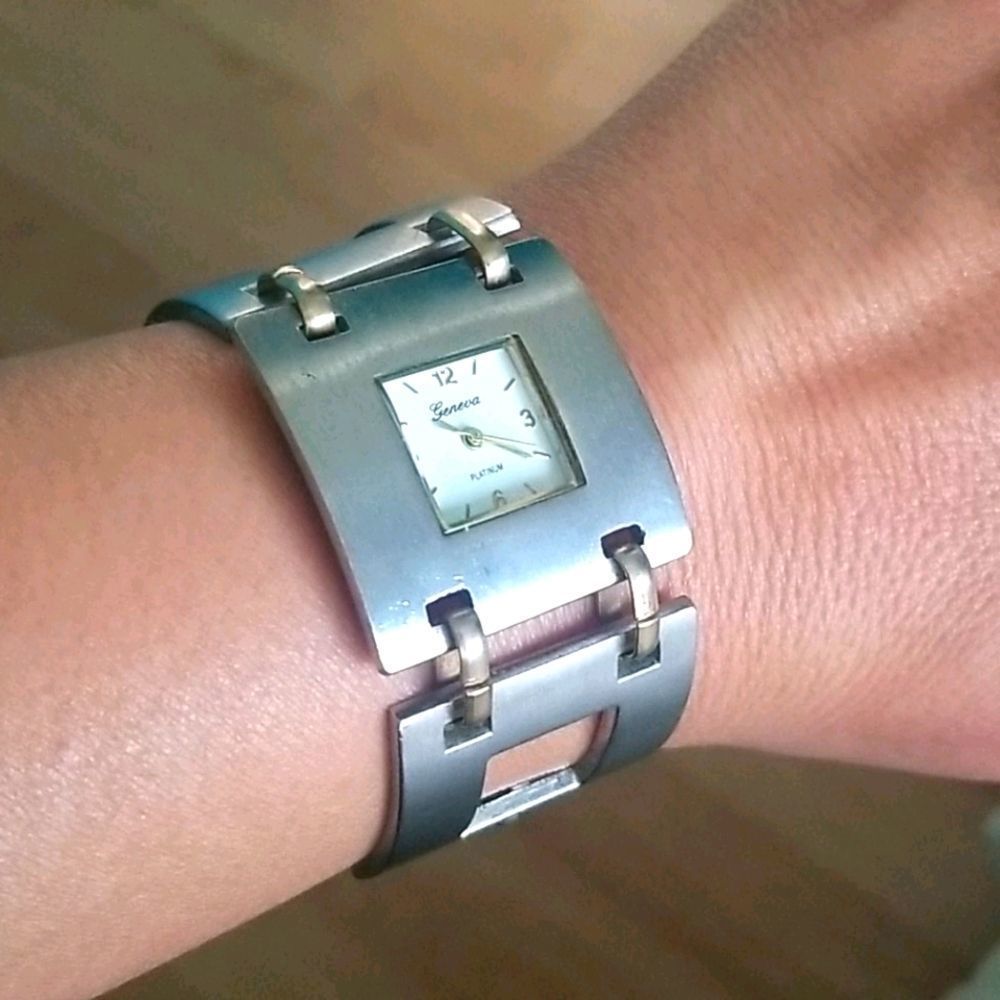 Silver-colored watch with gold-colored accents